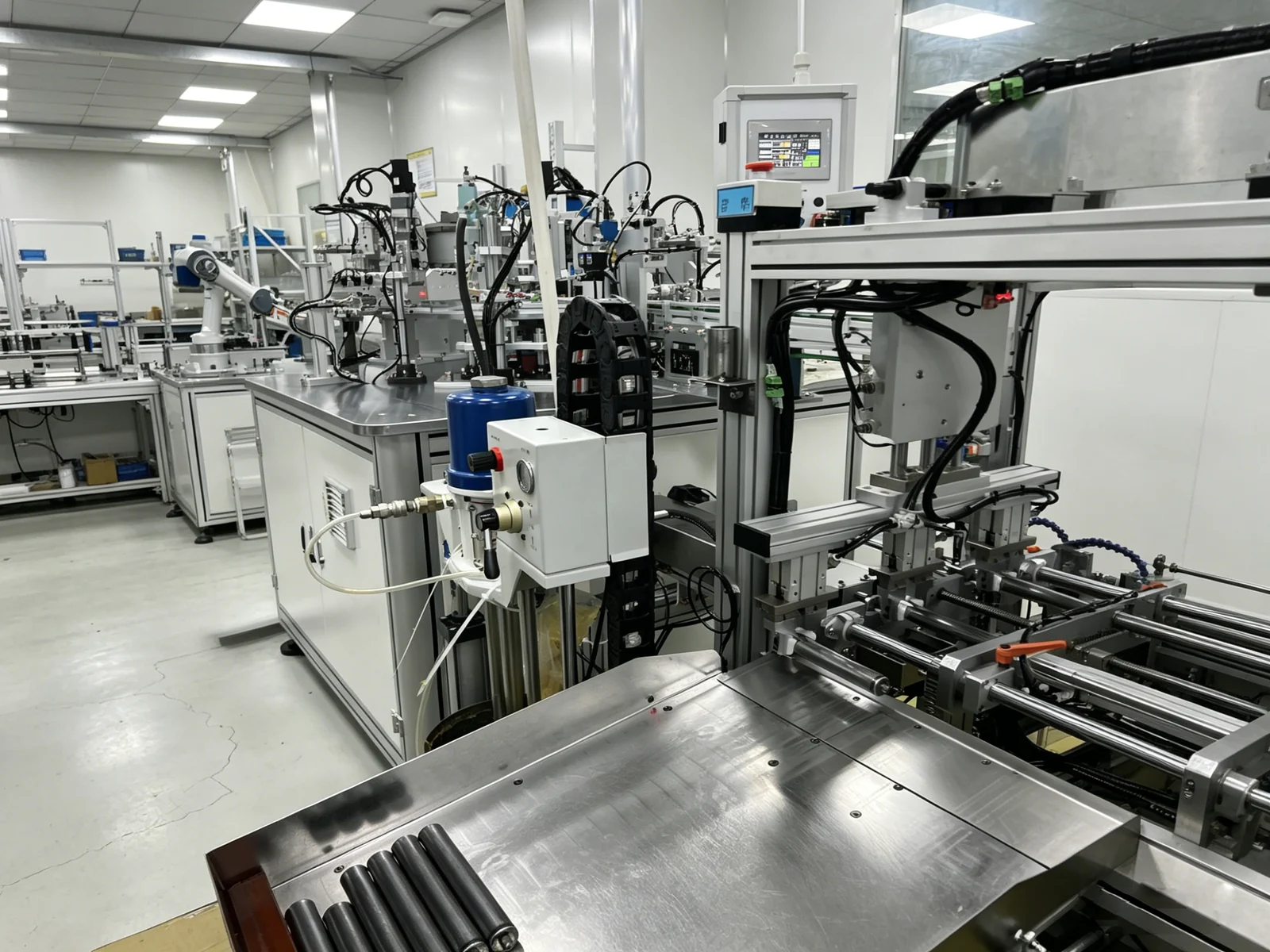 Gas spring assembly equipment, transfer tables and connected workstations