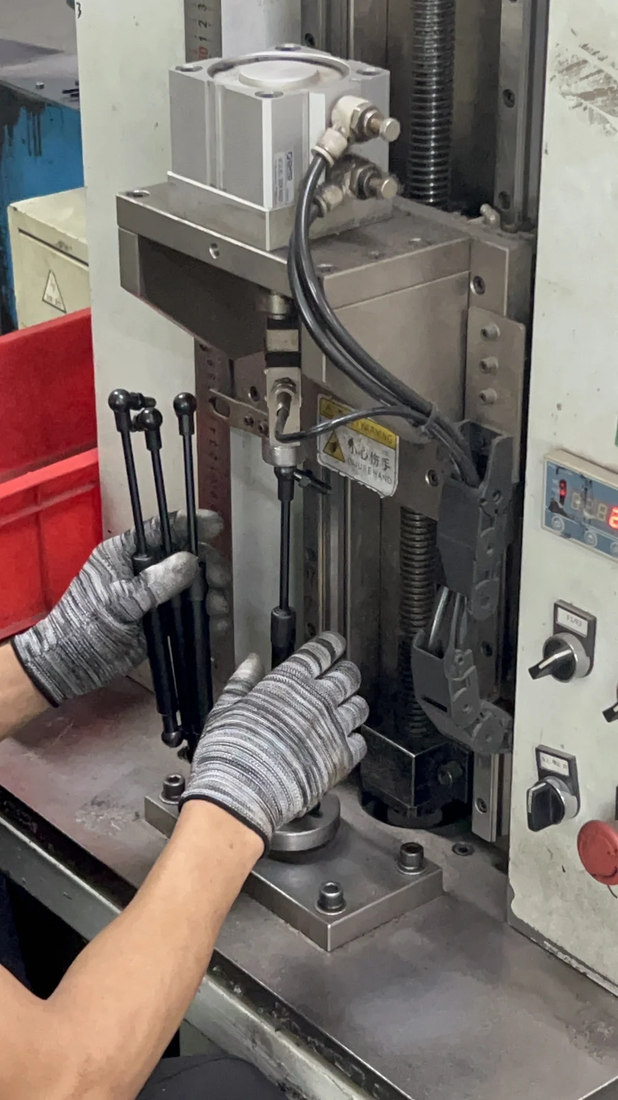 Operator running a gas spring assembly press