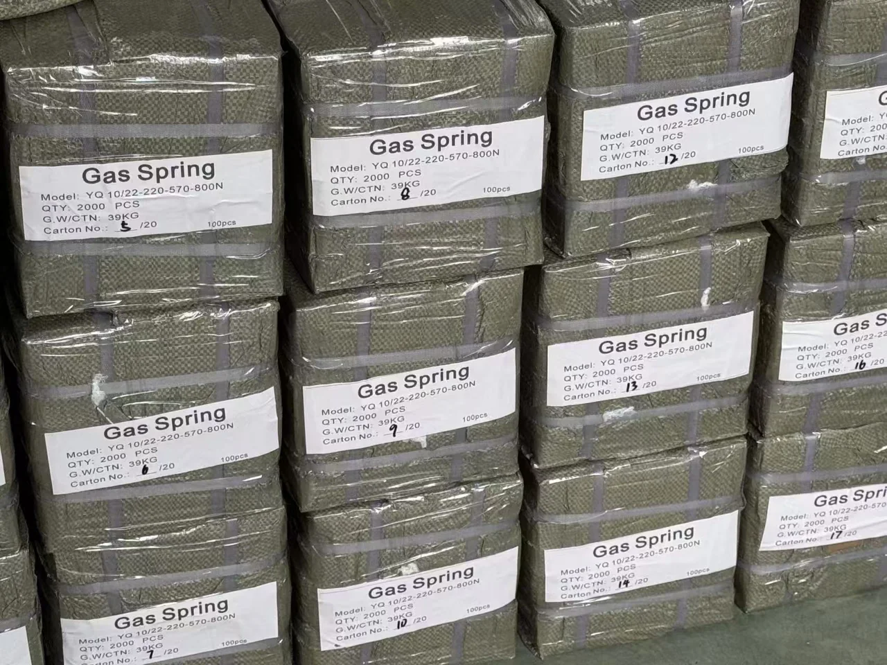 Wrapped and strapped gas spring cartons with specification and carton-number labels